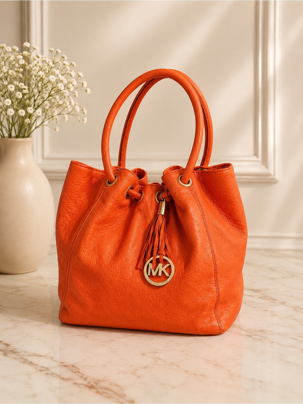 Michael Kors Orange Pebbled Leather Drawstring Tote tassel shoulder bag